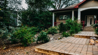 Landscaped home with brick walkways and steps. Lots of greenery. Photo
